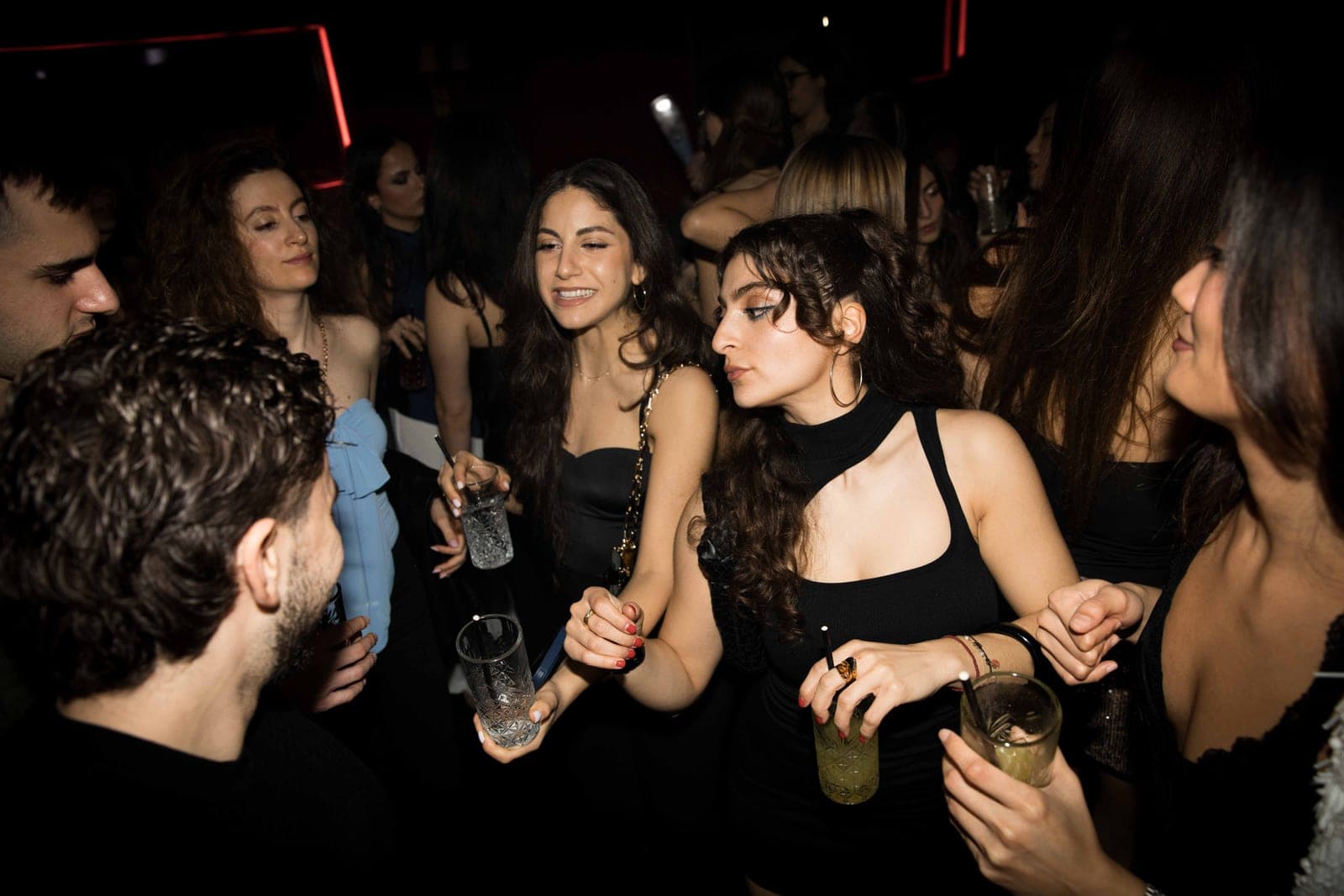 A dimly lit London nightclub interior with a bar and seating