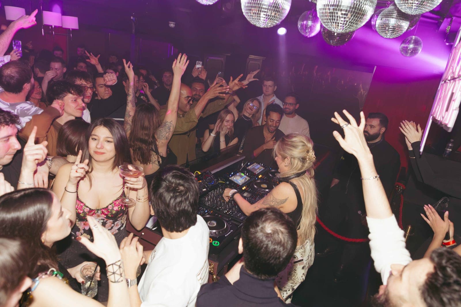 Glamorous Mayfair nightclub interior with warm lighting and plush seating