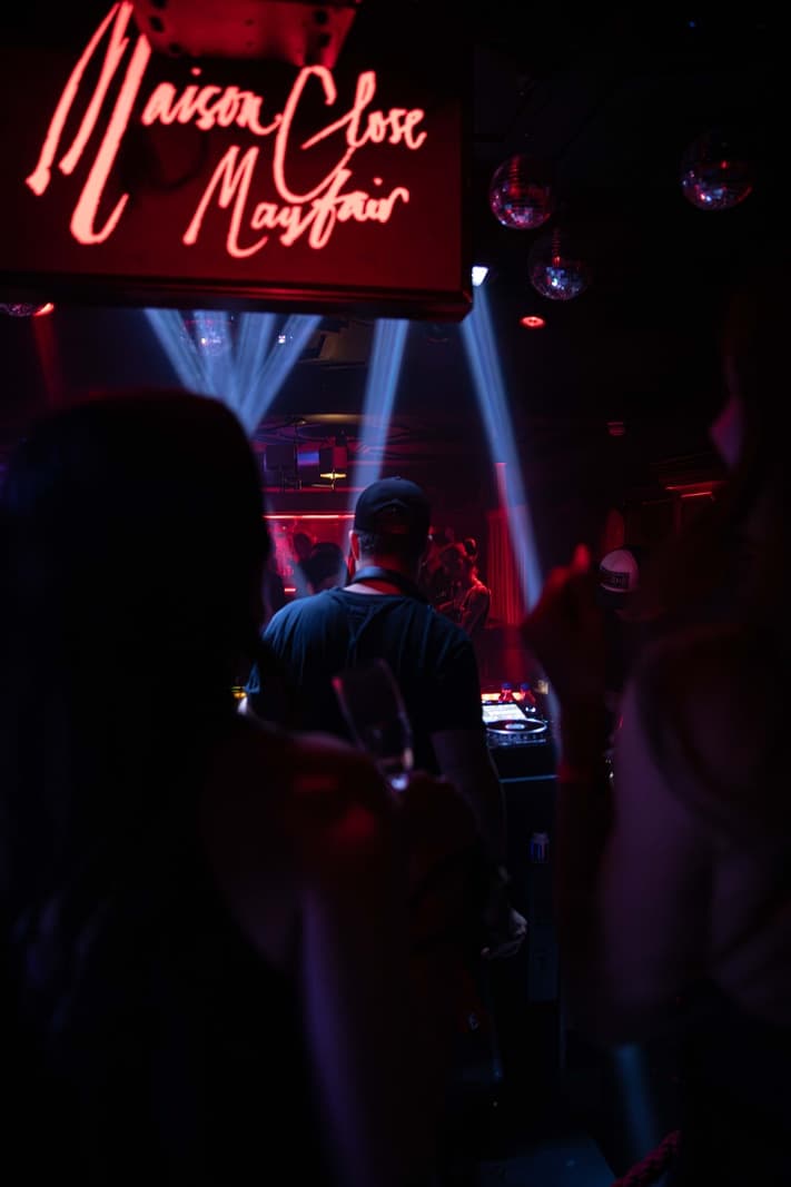 Crowd on a London nightclub dancefloor in front of the speakers at night