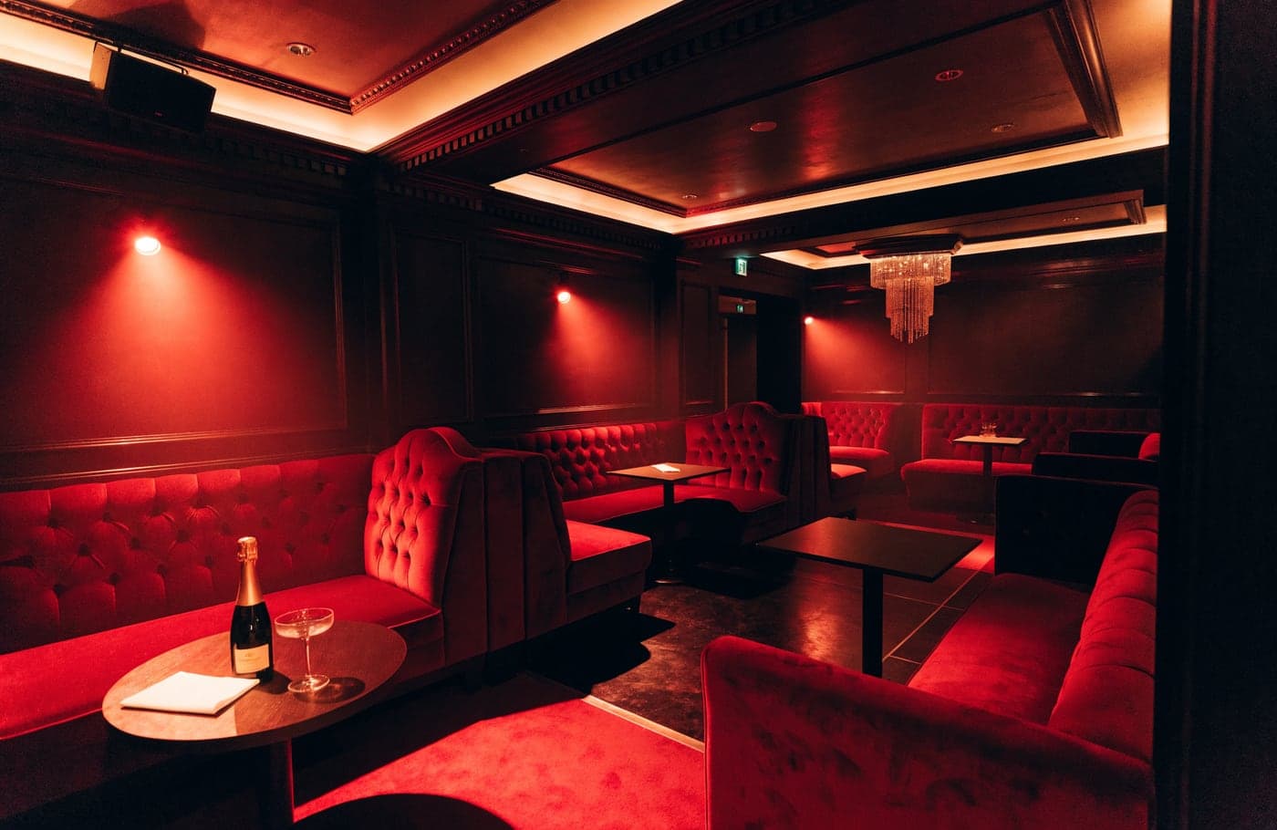 Red velvet booths, dark wood panelling and a chandelier inside Rumour on Dover Street