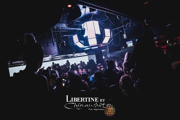 Crowd under a lit ceiling feature when 4 Winsley Street traded as Libertine by Chinawhite