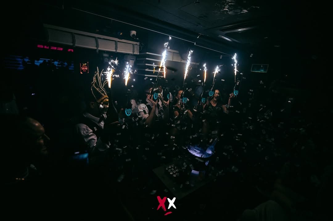 Sparkler bottles held up above the crowd at Luxx, before the club closed
