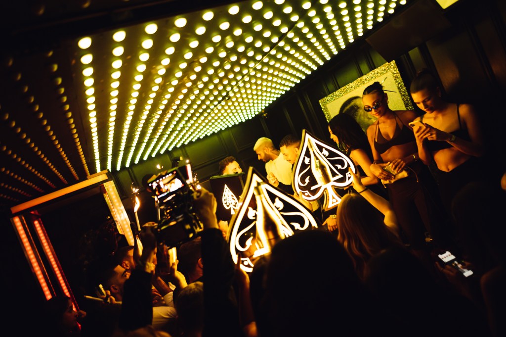 Guests partying at a high-end Mayfair club while dressed according to the London club dress code