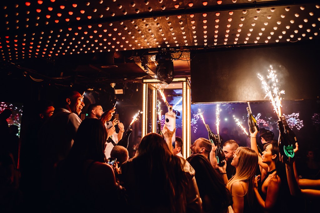 Tape London bottle girls and waiters carrying champagne bottles for a champagne show at Tape London.