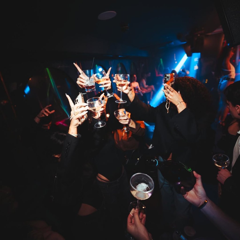Selene London guests partying and enjoying drinks at the club.