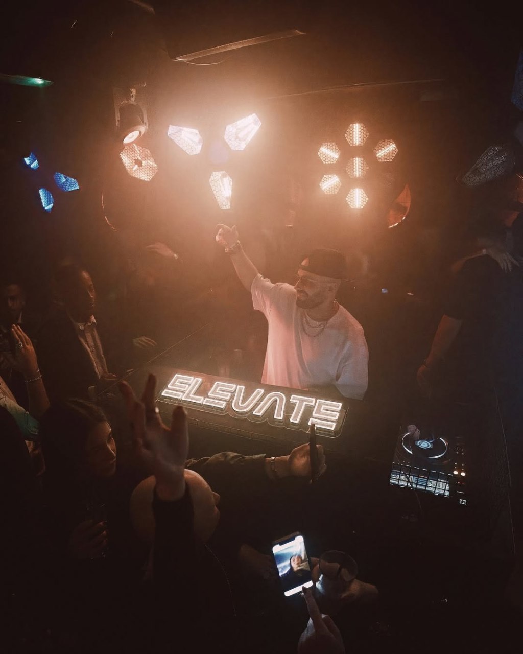 Tabu London guestlist clients in front of the Tabu club DJ booth.