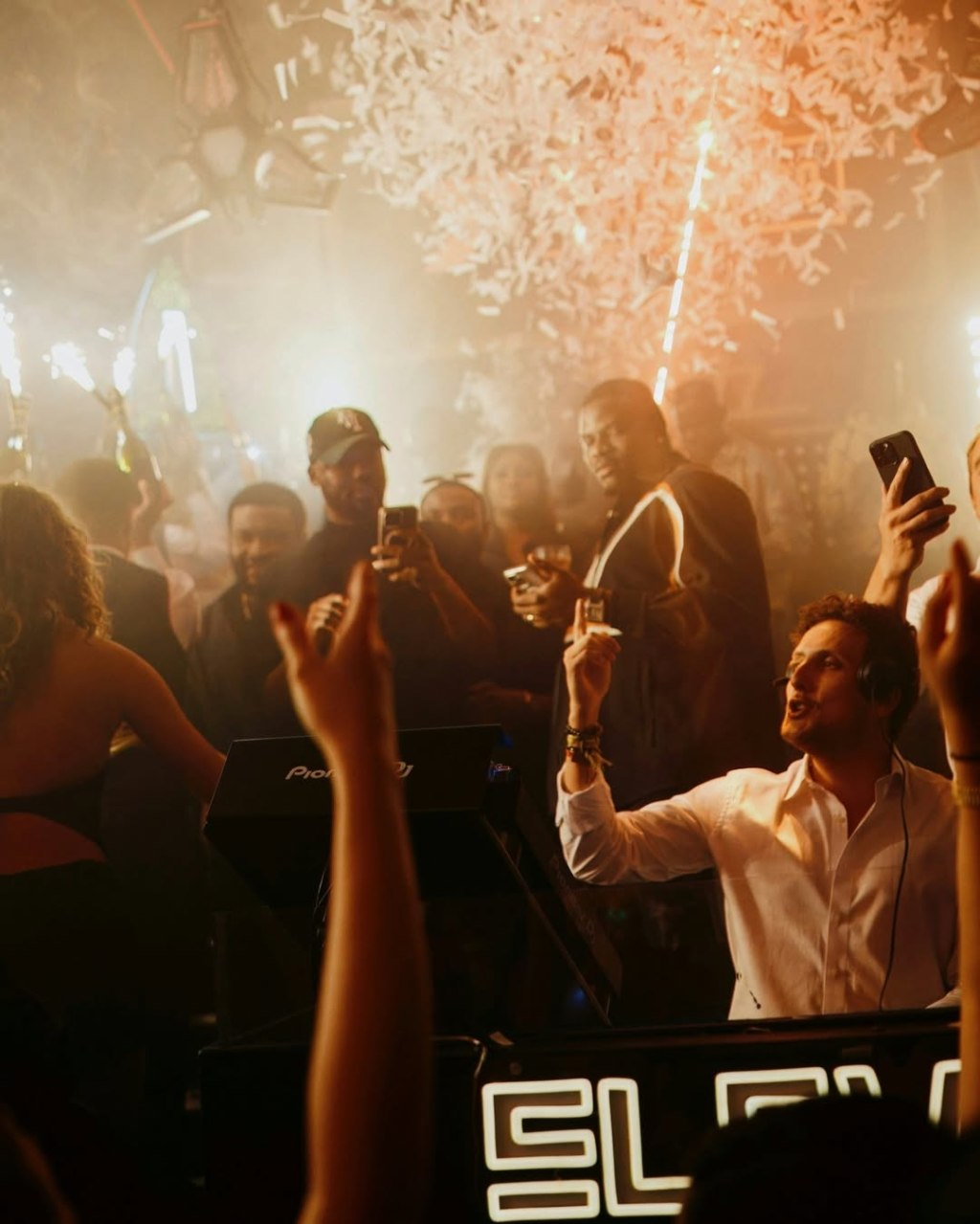 London Reign VIP table enjoying a bottle show and dancing while confetti falls from above.