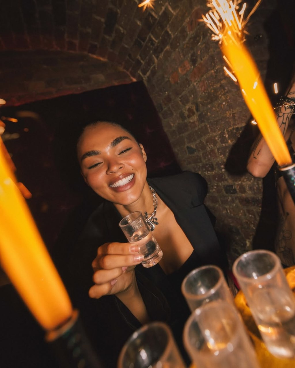 Luna London guestlist client drinking a shot in the club.