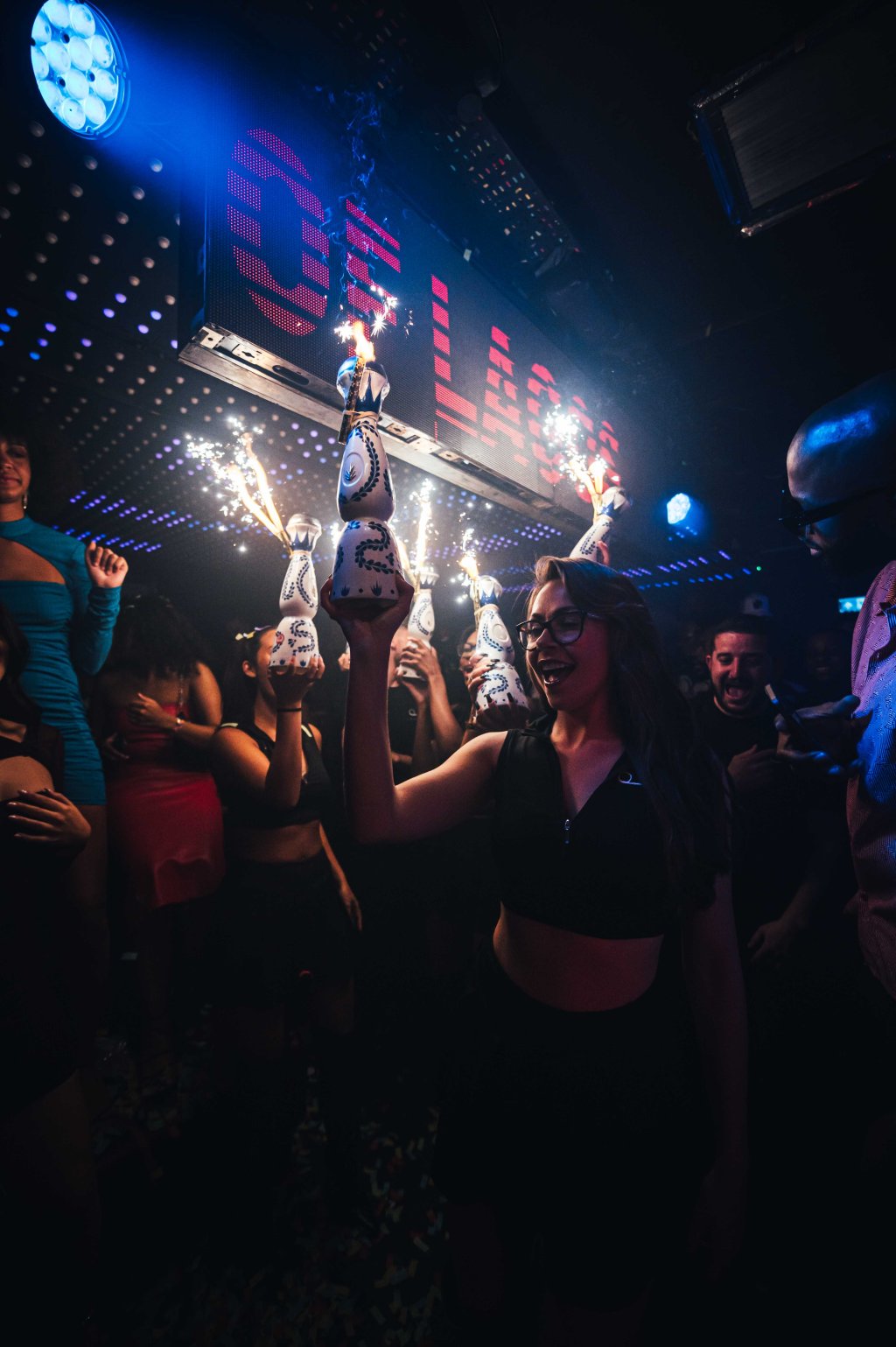 The view from a Tape London table while bottle girls carry premium tequila bottles to the table as part of a bottle show.