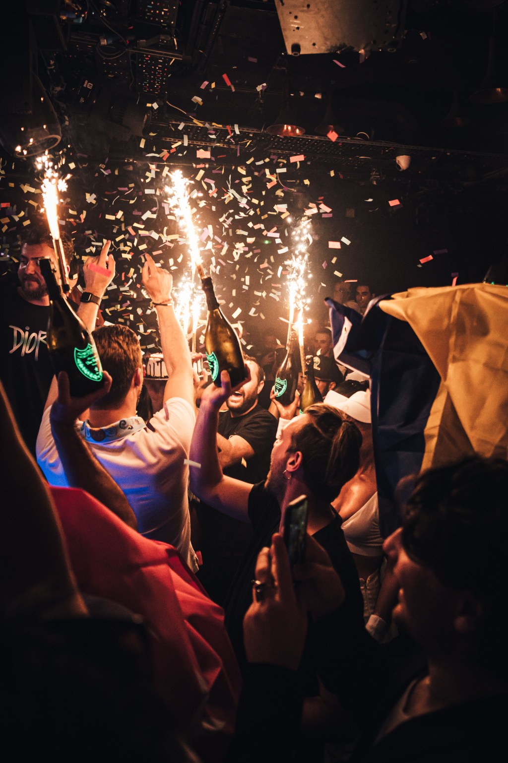 Champagne show that shows many people sitting at a Mayfair club table.