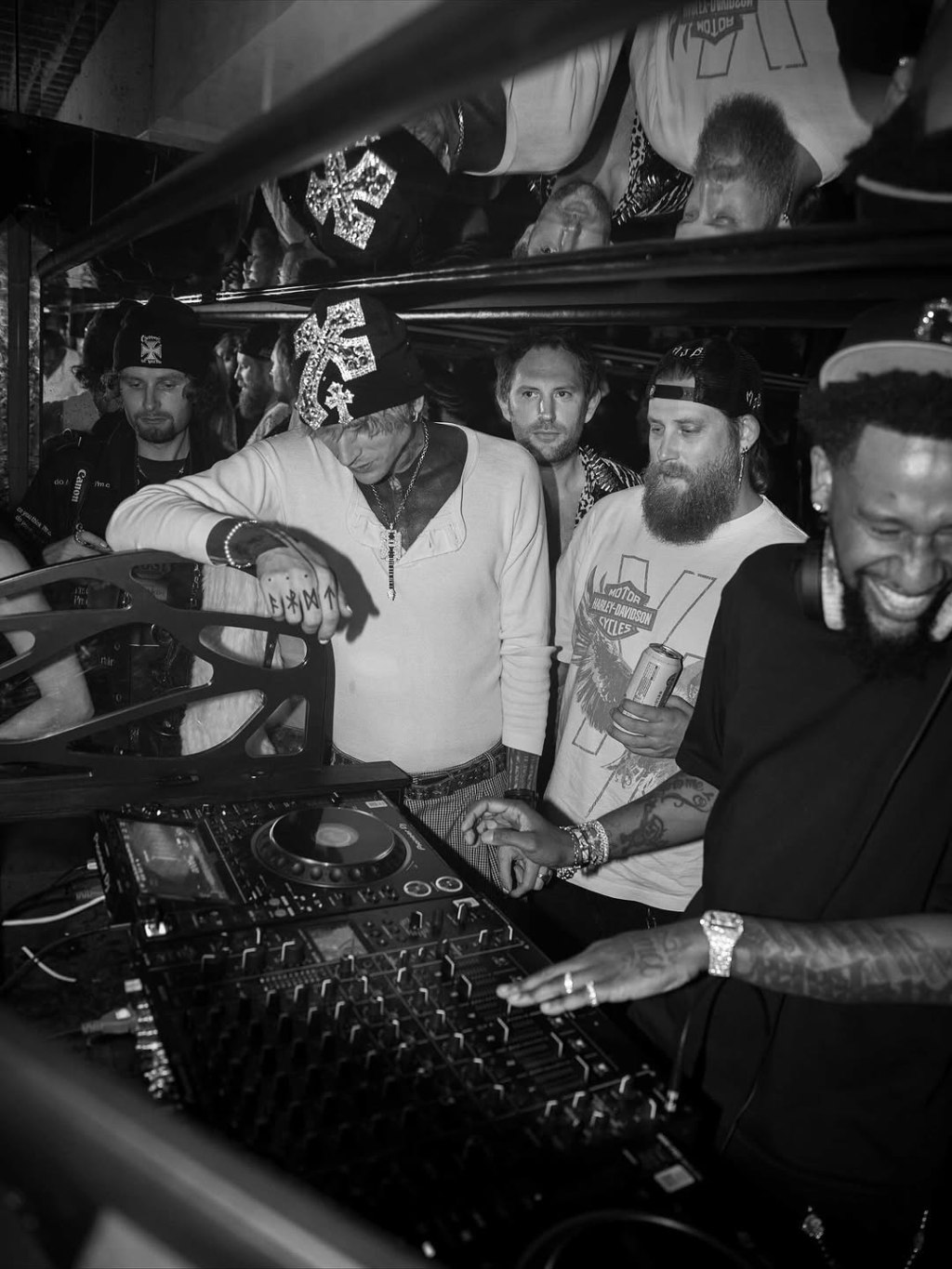 Machine Gun Kelly behind the DJ booth at a Rex Rooms party.