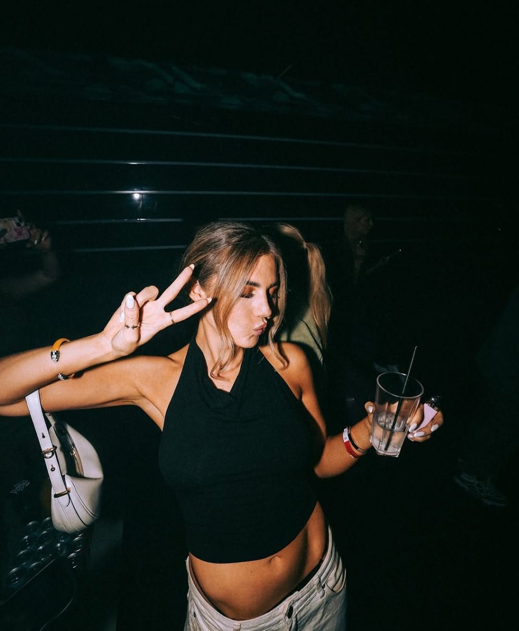 Girl posing for a photo inside Funky Buddha while dressed according to the Funky Buddha club dress code