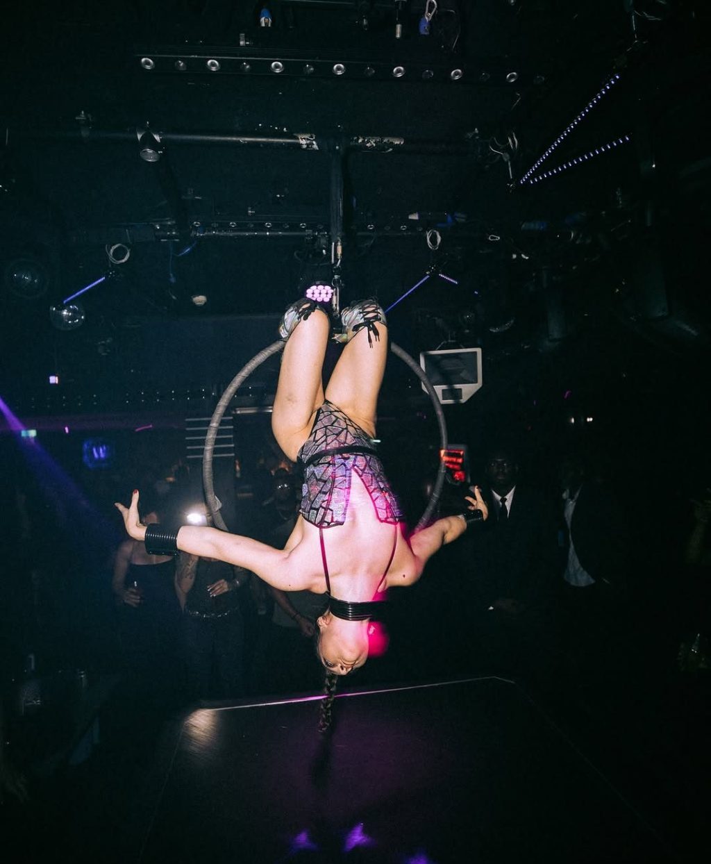 Aerialist floating upside down during a performance inside Funky Buddha Nightclub in London.