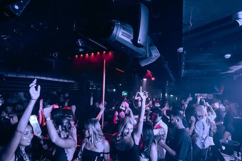 Guests with a Funky Buddha reservation dancing inside the club.