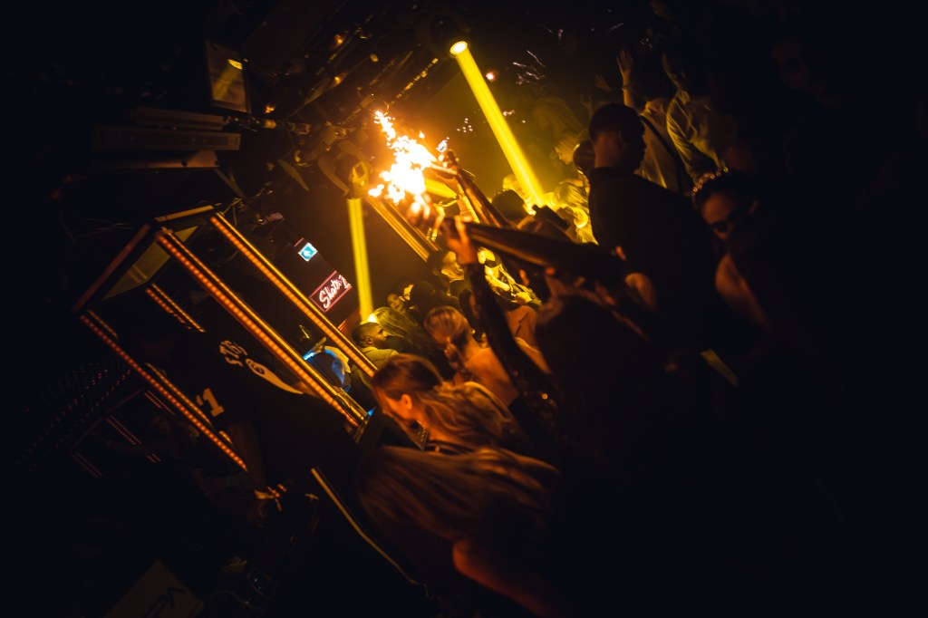 Guests dancing next to a VIP table at Tape London.