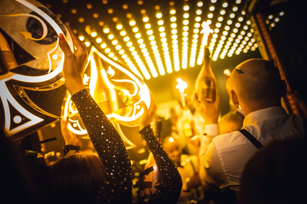 A champagne show where staff is carrying Ace of Spades bottles inside a high-end nightclub in Mayfair, London.